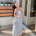 Woman wearing pastel blue Korean-style halter dress holding lollipop

