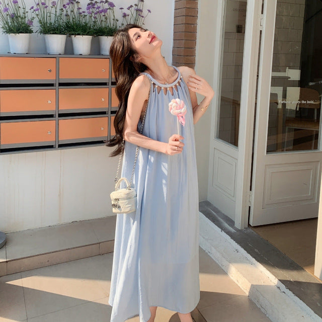 Woman wearing pastel blue Korean-style halter dress holding lollipop


